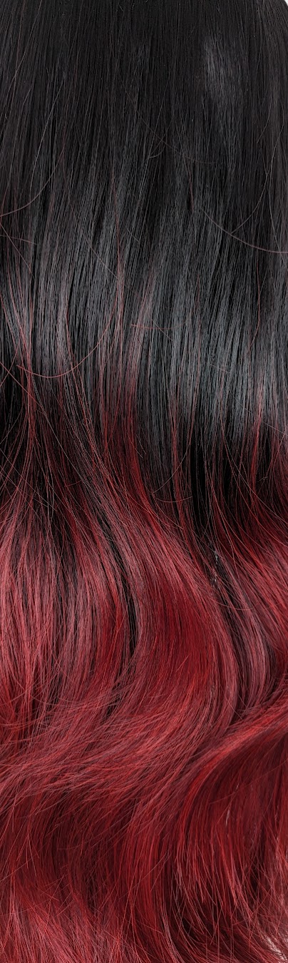 Black and red go together in perfect harmony. Cinnabar is our latest ombre of cool black and wine red. Styled in a blow out with long layers for movement. A light fringe frames the face.
