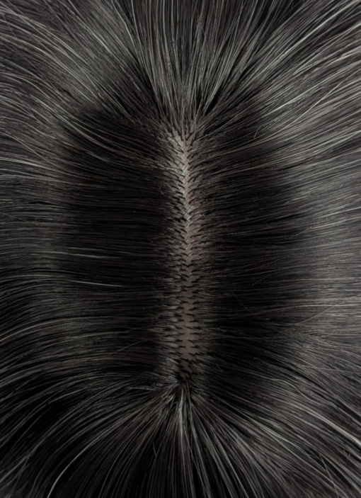 Dark brown shadowed roots melt into a light blonde with subtle pastel peach and pink highlights for that peek-a-boo effect. Long loose waves with long invisible layers adds movement and body. A light blunt sleek fringe.