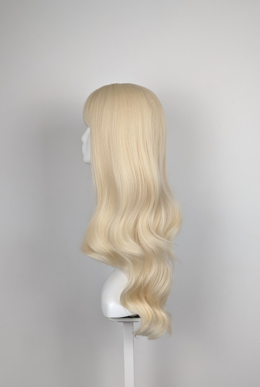 Waikiki gives effortless bohemian vibes, this light bleach blonde tone from roots to ends. Styled sleek from the crown of the head into long invisible layers with loose barrel curls. A long sleek fringe adds softness around the face.