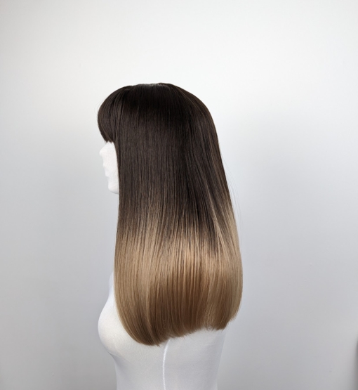 This long sleek blunt cut with a weightless fringe, is one of our favourite natural styles. Its warm brunette colour falls to the jaw, melting into a dirty blonde ombre.