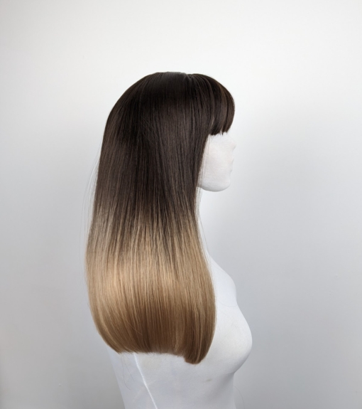 This long sleek blunt cut with a weightless fringe, is one of our favourite natural styles. Its warm brunette colour falls to the jaw, melting into a dirty blonde ombre.