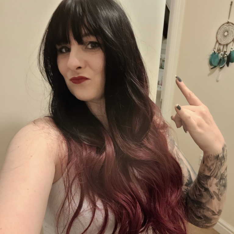 Black and red go together in perfect harmony. Cinnabar is our latest ombre of cool black and wine red. Styled in a blow out with long layers for movement. A blunt fringe frames the face.