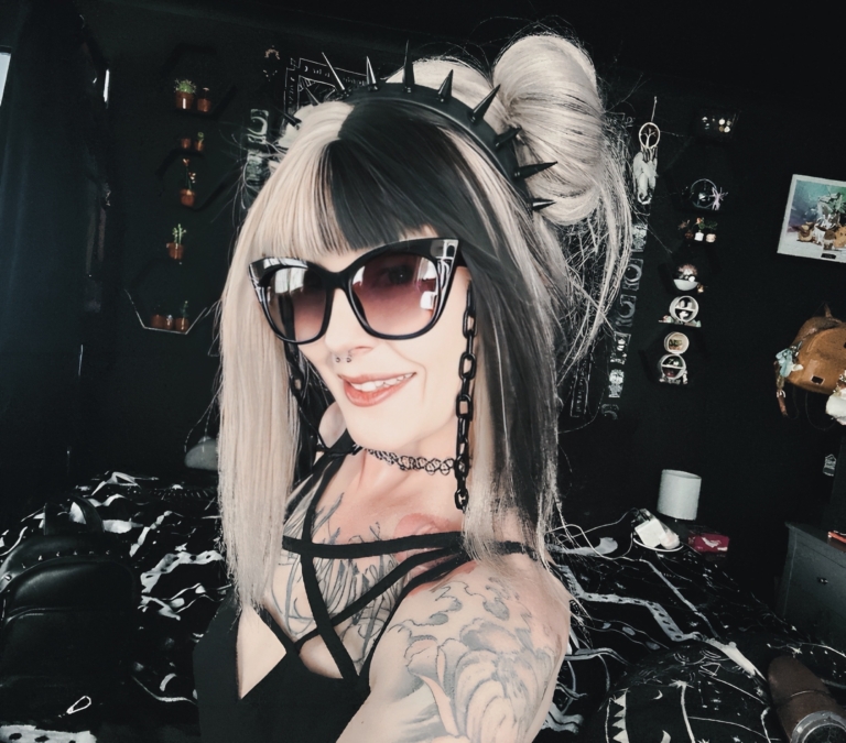 Sterling blonde with a mix of grey. A slice of jet black for added definition takes this style to the next level. Black tones come from the nape of the neck. Giving a peek-a-boo effect. Loose waves fall just past the shoulders, a blunt sleek fringe carries the split colour.