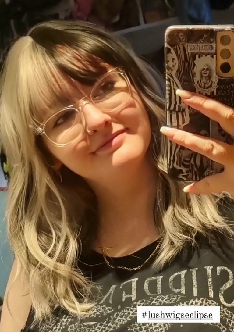 Sterling blonde with a mix of grey. A slice of jet black for added definition takes this style to the next level. Black tones come from the nape of the neck. Giving a peek-a-boo effect. Loose waves fall just past the shoulders, a blunt sleek fringe carries the split colour.