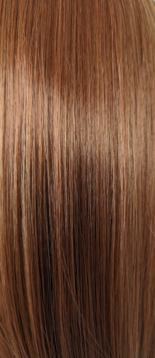 A mixture of brunette and cinnamon colours. A sleek long bob with a blunt fringe. A combination of stylish and sassy.