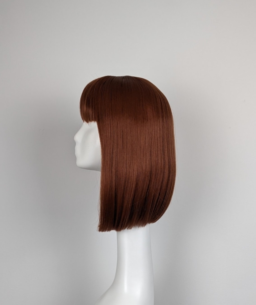 A mixture of brunette and cinnamon colours. A sleek long bob with a blunt fringe. A combination of stylish and sassy.