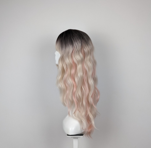 Dark brown shadowed roots melt into a light blonde with subtle pastel peach pink strands for that peek-a-boo effect. Long loose waves with long invisible layers adds movement and body. A light fringe frames the face.
