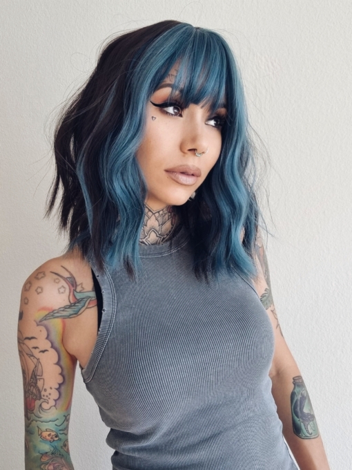 This wavy bob comes to life with a face framing slice of turquoise colour. Thats carried into the fringe and adds a peek-a-boo at the sides. A dark brown from roots to tips.