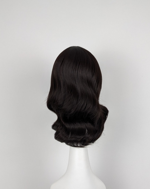 Brown natural loose curl long bob. Warm brunette tone from roots to tips with a fringe.