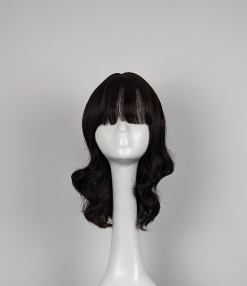 Brown natural loose curl long bob. Warm brunette tone from roots to tips with a fringe.