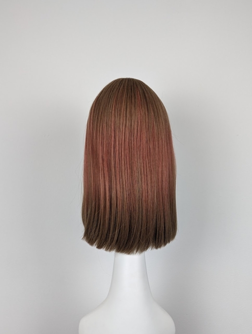 Caramel brown from the roots blende into a sandy pink, with brown dip dyed ends. We love this play on colour. A sleek long bob with a airy fringe.