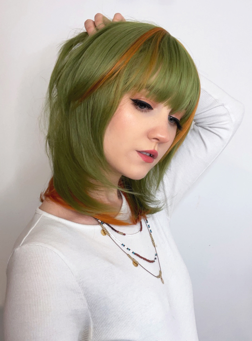 Super cute, unique and fresh. A shaggy cut style in a earthy green colour with highlights of burnt orange.