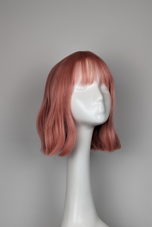 Peach bob with a sight wave. Creamy peach from roots to tips. A light fringe frames the face.