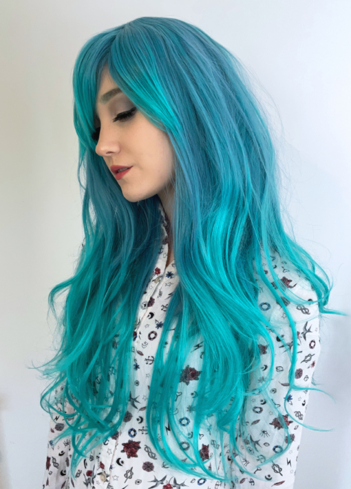Shades of blue fade into a lush turquoise at the ends. Subtle waves and layers add shape & body. A longer fringe can be styled to suit you - however you want to wear it. This wig is perfect for styling into something voluminous with those big iconic swoopy bangs.