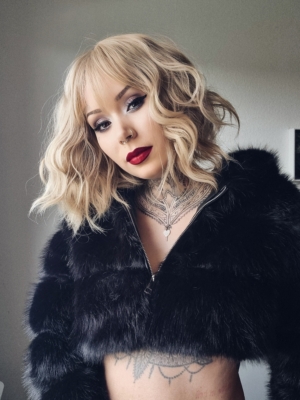 This bob is styled into loose tousled waves with plenty of volume. A light blonde shade from roots to tips. With a sleek blunt fringe