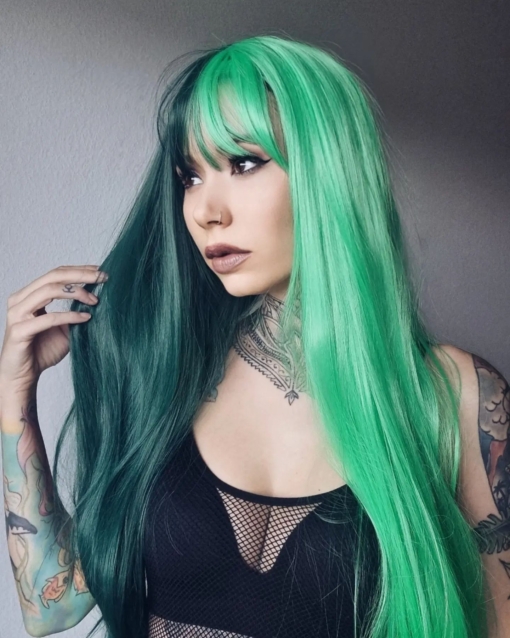 Bayou takes on the dramatic colour divide. If you’re looking for a coal black hue and a bright green, split either side of the centre parting. Long to the waist and thick throughout this sleek style.
