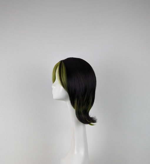 This cute bob with a 60s style flick comes in a jet black colour. Its fringe-less but has two green layers at each side of the face. The green streaks add a peek-a-boo effect at the back and on the sides.