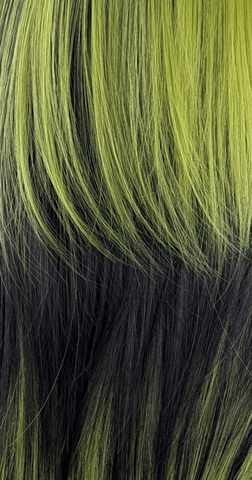 Aurora - Lush Wigs UK Blocks of leaf green colour are carried through the black lengths of this sleek long bob. Sleek and choppy with lots of layers. The green colour is carried into the fringe and on top of the head. Lots of green undertones for a peek-a-boo effect.