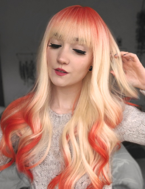 This natural twist bleach blonde wig with bright orange roots and dip dye at the ends. A sleek long style with layers for movement and bounce. With a full fringe to peep from under.