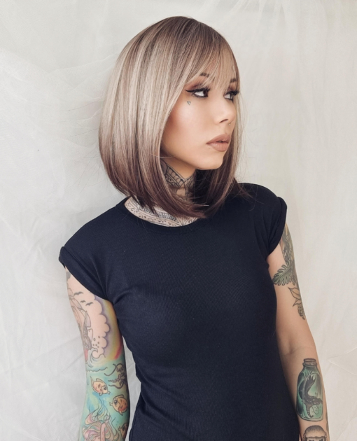 This natural wig is simple with a twist on colour adds some spice. A sleek long bob with a light fringe. Carries dark brown shadowed roots that blend into this light blonde colour, finished off with a block of dark brown at the tips. A natural mix of colour that sets this look.