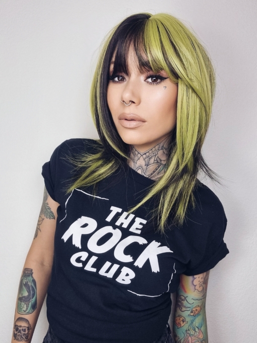 This vivid and bright wig has a natural twist of black and lime green. Blocks of colour set the look for this sleek long bob (lob) with a light airy fringe that carries the colour.