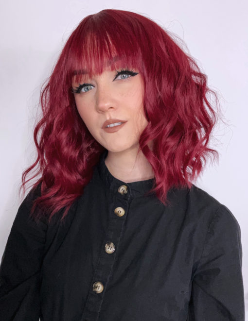 This vibrant and rich colour comes in a deep cherry shade, from roots to tips. Loose beachy waves fall to the shoulders, with an airy fringe to frame the face.