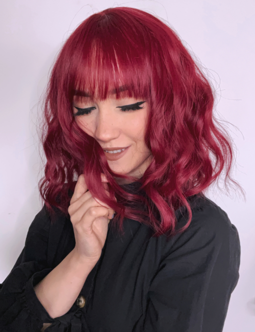 This vibrant and rich colour comes in a deep cherry shade, from roots to tips. Loose beachy waves fall to the shoulders, with an airy fringe to frame the face.