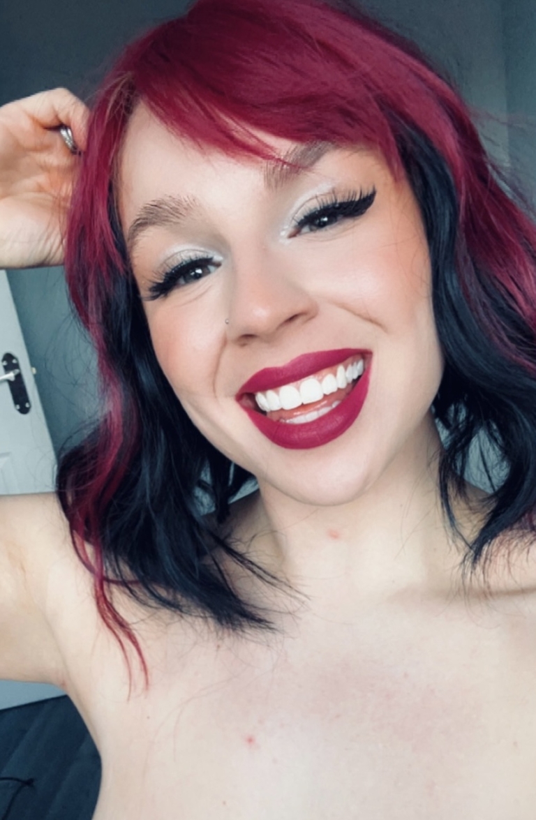 Myth - Lush Wigs UK This wavy bob comes to life with a face framing slice of bright purple colour. Thats carried into the sleek fringe and adds a peek-a-boo at the sides. A soft black colour from roots to tips.