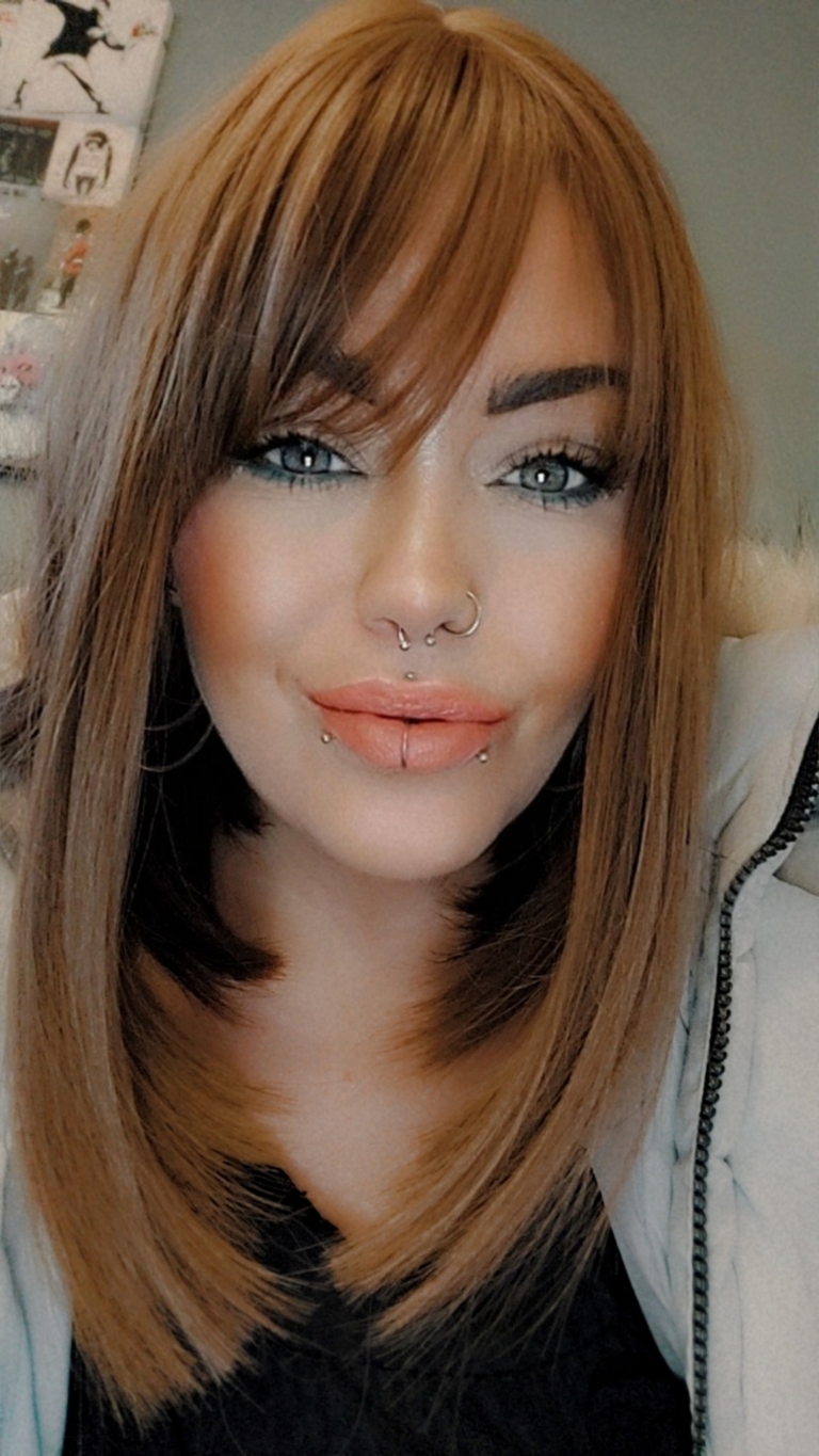 This earthy natural light brown wig is simple and chic. It certainly lives up to the name. A sleek long bob (lob) that curls just under at the ends. With a light fringe create the perfect shades for a natural look.