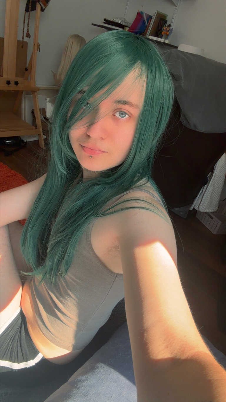 Forest - Lush Wigs UK This dark green wig from roots to tips. Styled sleek with long layers falling to the waist. The fringe is long and sleek, wear it to the side or parted for curtain bangs.