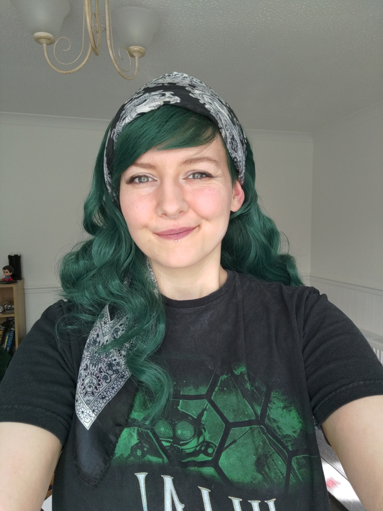 This dark green wig from roots to tips. Styled sleek with long layers falling to the waist. The fringe is long and sleek, wear it to the side or parted for curtain bangs.