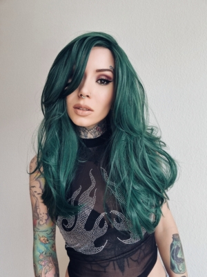 This dark green wig from roots to tips. Styled sleek with long layers falling to the waist. The fringe is long and sleek, wear it to the side or parted for curtain bangs.