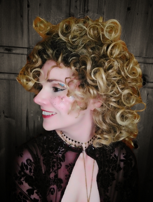 Calling all dancing queens! Stargaze is a vibrant and fresh style. Dark brown roots with ash blonde locks. This tight spiral curl wig is perfect for those who want to try a mop of curls without hours of styling!