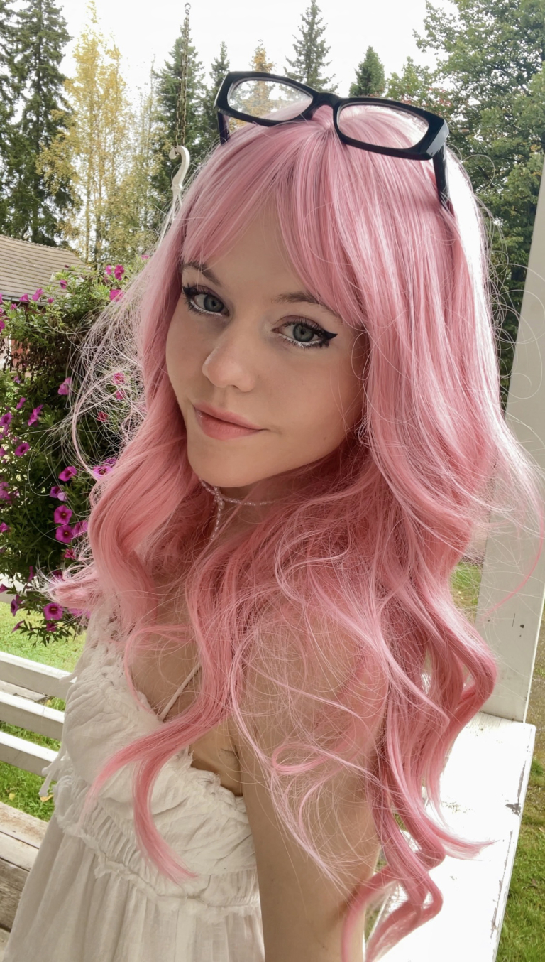 Pink from roots to tips. A blend of light pink and white stands of hair make this rose pink colour, from roots to tips. Styled in waves that fall to the waist. The light fringe finishes the look.