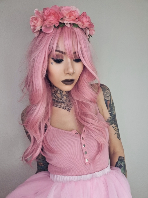 Pink from roots to tips. A blend of light pink and white stands of hair make this rose pink colour, from roots to tips. Styled in waves that fall to the waist. The light fringe finishes the look.