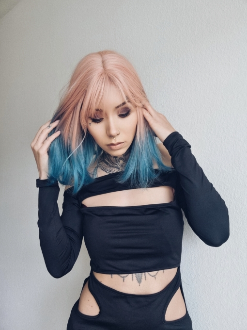 Goo is a grungy vivid style. A long bob (lob) with a mix of peach and blonde from the roots that melts into a muted blend of light blue and navy strands of hair produce this colour. Sleek style with an airy fringe.