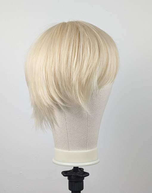 Pixie style in a blonde colour from roots to tips. Cut in short layers to the nape of the neck. Brush it forward for a full fringe or part for long bangs that frame the face.