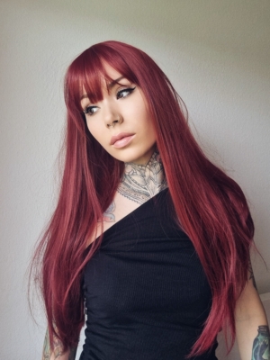 This sleek style comes in dark red wine colour from roots to tips. Cut into long layers that fall to the waist. Finished in a barrel brush blow out, with a blunt fringe.