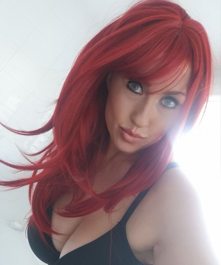 Smitten - Lush Wigs UK This sleek style comes in a vivid fire engine red colour from roots to tips. Cut into long layers that fall to the waist. Finished in a barrel brush blow out, with a sleek blunt fringe.