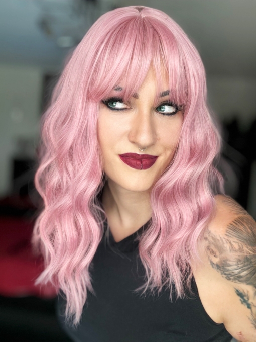 A baby pink and light blonde colour mix make this pastel hue from roots to tips. A long bob styled into a loose wave with a sleek blunt fringe.