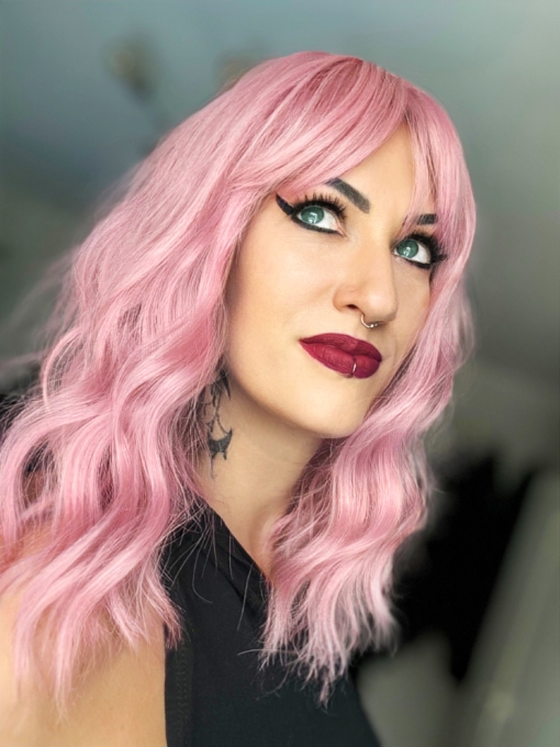 A baby pink and light blonde colour mix make this pastel hue from roots to tips. A long bob styled into a loose wave with a sleek blunt fringe.