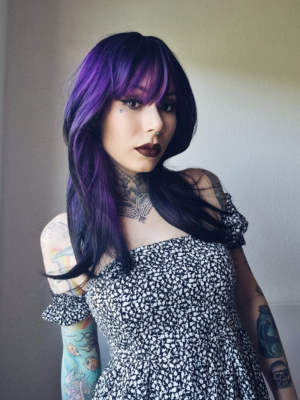 This natural twist of soft black and a deep purple pop of colour. Soft black roots blend into this purple hue with black tips. A sleek long style with long layers at the back that have a blow out look. Face framing layers at the front make this style easy to maintain. With a full sleek blunt fringe.