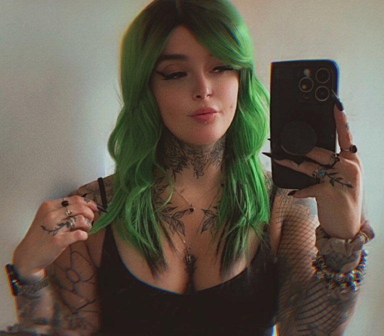 Green and bold. Dark brown roots blend into this bright two tone green colour, with a slice of dark brown at the nape of the neck. For a peek-a-boo effect. Styled into a loose wave with a blunt fringe.