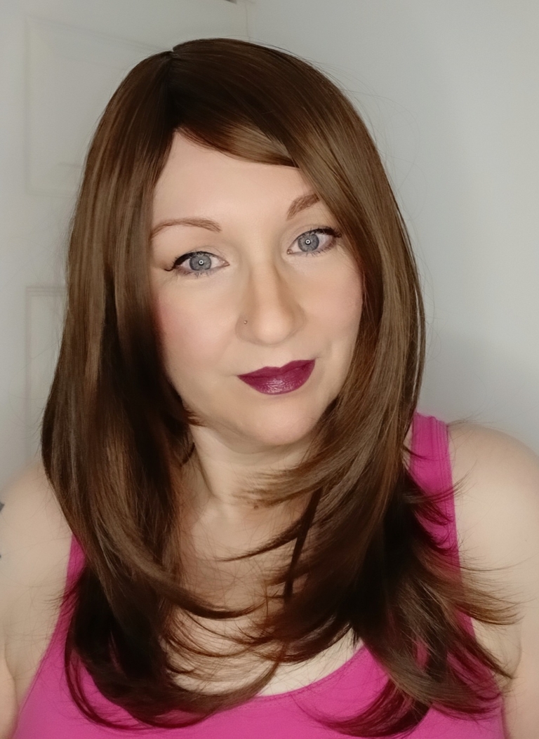 Bruna is a natural mix of auburn and brown to create this beautiful warm colour from roots to tips. Sleek long bob with layers are styled in a blow out for volume. Finished with a blunt fringe.