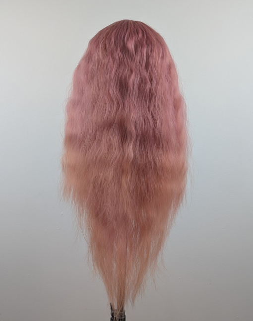 Outlet #140 - Lush Wigs UK This wig is so fluffy. A soft crimped mermaid waves style in a blend of coral pink that fades into a warm-toned peach. The sleek long fringe is versatile to be worn to suit your look.