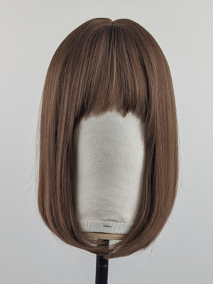 Outlet #144 - Lush Wigs UK This natural brown colour wig is simple and easy to wear. Its rich brown shades come to life with golden-copper undertones. A sleek long bob (lob) that curls just under at the ends. With a light sleek fringe.