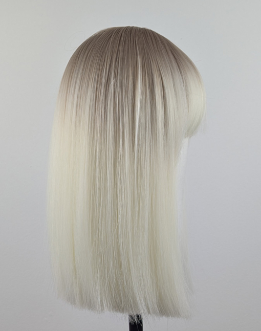 Outlet #147 - Lush Wigs UK A platinum blonde colour with a muted lemon undertone, producing a bleach blonde effect. A sprinkle of sandy blonde roots, creating a natural feel. Poker straight, long one length bob (lob) with a sleek full blunt fringe.