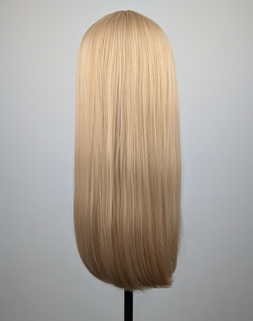 A long straight one-length wig that falls to the waist. This natural light honey blonde colour from roots to tips comes with a sleek blunt fringe.