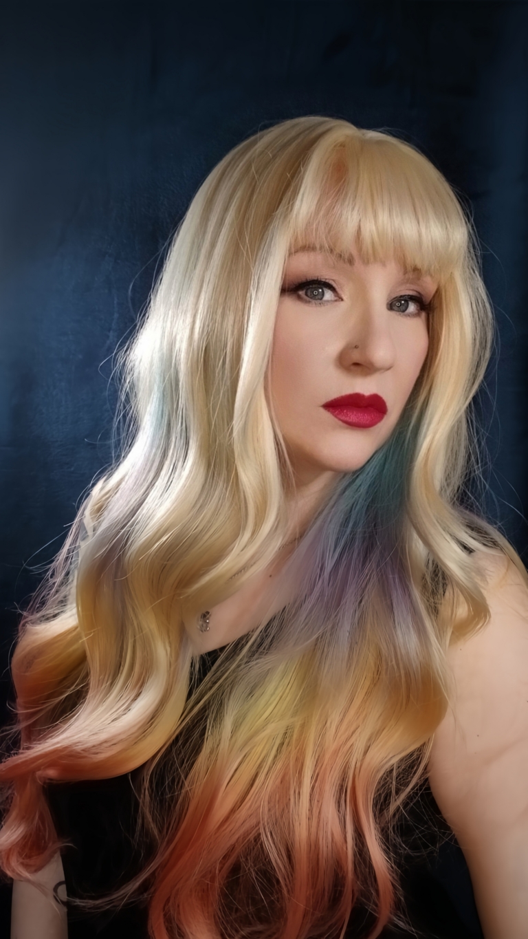 Zeus - Lush Wigs UK This multi-colour wig is a mixture of purple, blues, limes, greens and peach. From the nape of the neck giving a peek-a-boo effect. A natural blonde colour from the roots, thats carried into the sleek blunt fringe. Long and curly with invisible layers for bounce and volume.