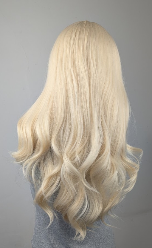 Waikiki - Lush Wigs UK This wig has a light golden blonde colour from roots to tips. It's styled sleek with large blow out curls at the ends for volume. A sleek blunt fringe frames the face.
